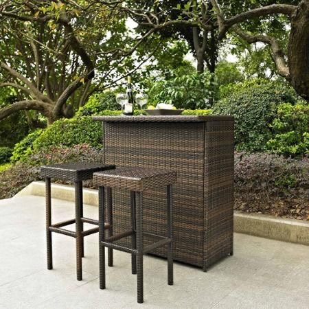 Outdoor rattan bar table with matching bar stools on a patio, featuring dark woven wicker design by Outadore Space