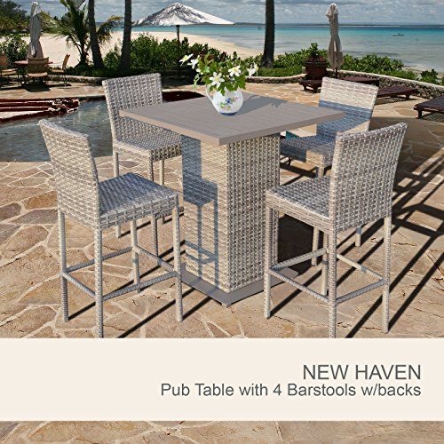 Wicker pub table with four barstools in an outdoor patio setting overlooking the beach, designed by Outadore Space