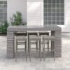 Long outdoor wicker bar table with matching bar stools in a modern patio setting, designed by Outadore Space