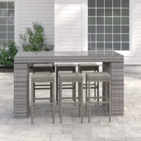 Long outdoor wicker bar table with matching bar stools in a modern patio setting, designed by Outadore Space