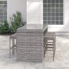 Long outdoor wicker bar table with matching bar stools in a modern patio setting, designed by Outadore Space