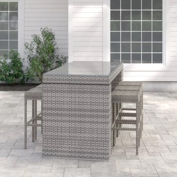 Long outdoor wicker bar table with matching bar stools in a modern patio setting, designed by Outadore Space
