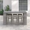 Long outdoor wicker bar table with matching bar stools in a modern patio setting, designed by Outadore Space