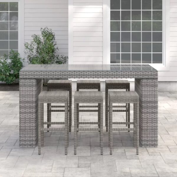 Long outdoor wicker bar table with matching bar stools in a modern patio setting, designed by Outadore Space