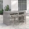Long outdoor wicker bar table with matching bar stools in a modern patio setting, designed by Outadore Space