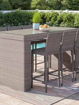 Outdoor wicker bar table with matching stools placed on a modern patio, durable outdoor furniture by Outadore Space