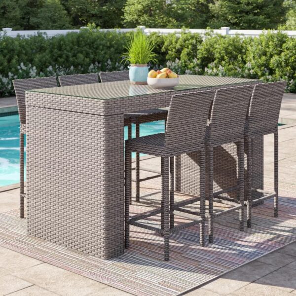 Outdoor wicker bar table with matching stools placed on a modern patio, durable outdoor furniture by Outadore Space