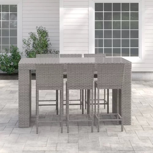 Outdoor wicker bar table set with matching bar stools arranged on a modern patio, designed by Outadore Space