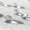 Waterproof outdoor fabric with water droplets showcasing moisture-resistant material used in Outadore Space furniture