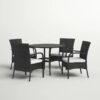 Outdoor rattan dining set with cushioned chairs and round table on a patio, crafted by Outadore Space