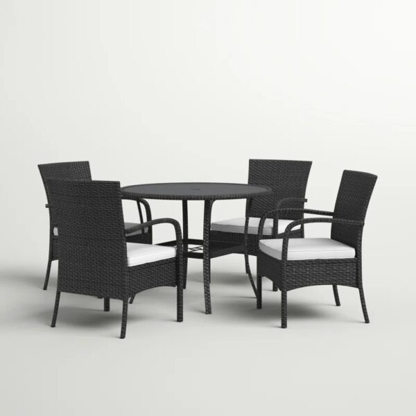 Outdoor rattan dining set with cushioned chairs and round table on a patio, crafted by Outadore Space