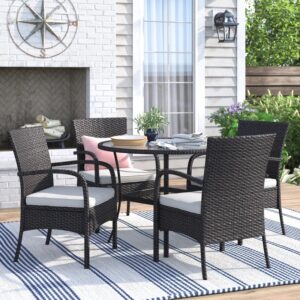 Outdoor rattan dining set with cushioned chairs and round table on a patio, crafted by Outadore Space