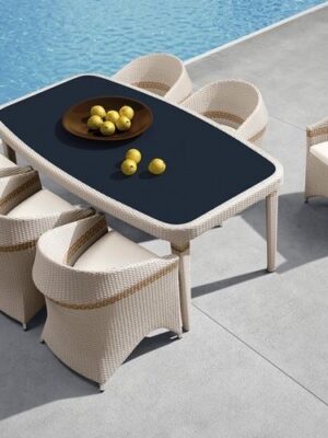 Outdoor poolside dining set with wicker chairs and a modern table from Outadore Space