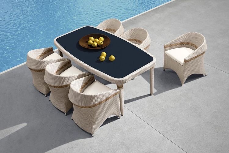 Outdoor poolside dining set with wicker chairs and a modern table from Outadore Space